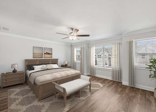 The elegant primary bedroom featuring a plush bed, stylish nightstand, and accent chair.