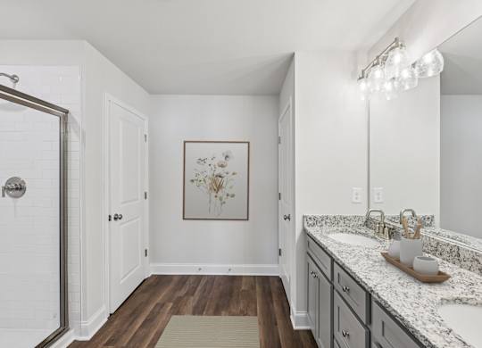 A luxurious primary bathroom with a double vanity and spacious walk-in shower.