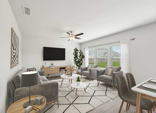 A living room with a grey couch, a coffee table, and a television.