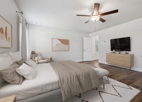 4-bedroom rental with large primary bedroom. Offers room for a king size bed with tons of natural light from the oversized windows. There is a ceiling, attached walk-in closet &