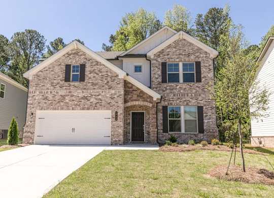 Exterior of the Atwood, two story home with a private driveway and attached garage.