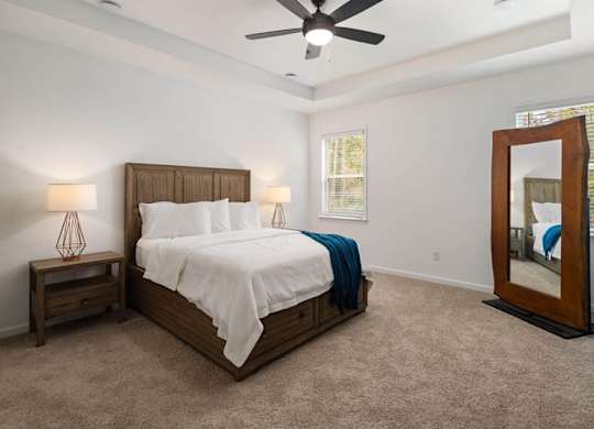 Primary Bedroom with king size bed and large window letting in nice natural light.