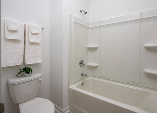 Secondary suite bathroom with a tub and shower combination