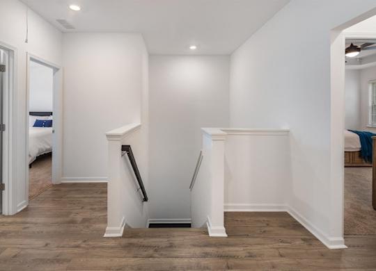 Hallway and stairwell guiding you up to the loft area.