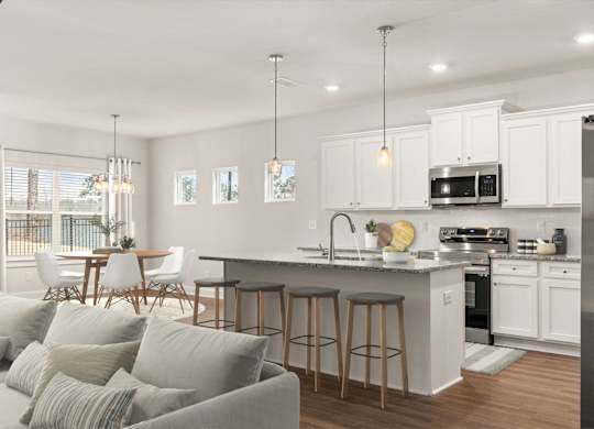 A modern kitchen with a bar area and a dining table.