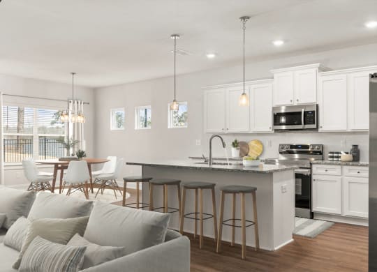 an open kitchen and living room with a couch and a table
