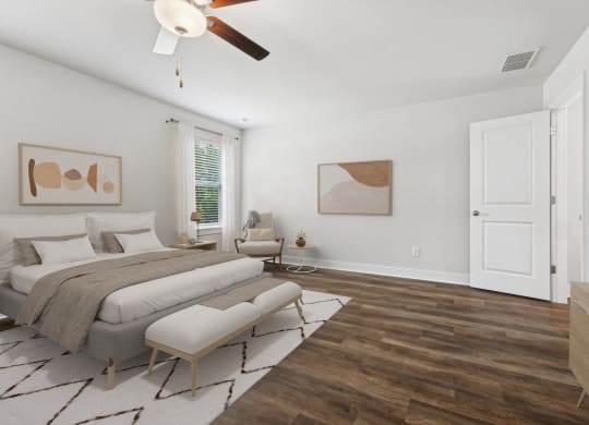 a bedroom with a large bed and a ceiling fan