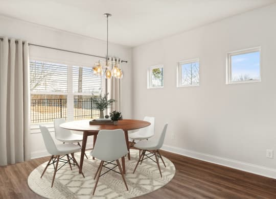 a dining room with a table and chairs and a window
