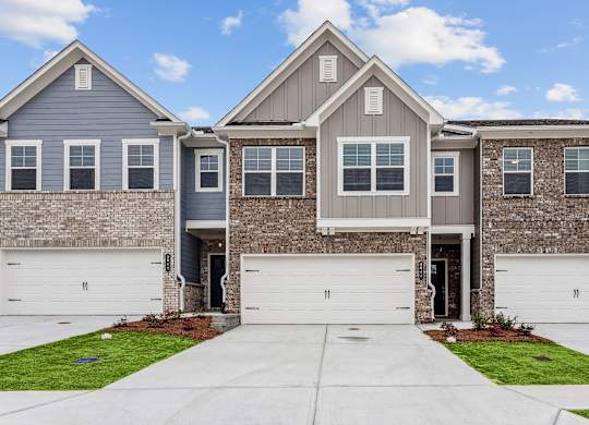 Exterior shot of Carlton Crossing, two story townhome with a private driveway and attached garage.