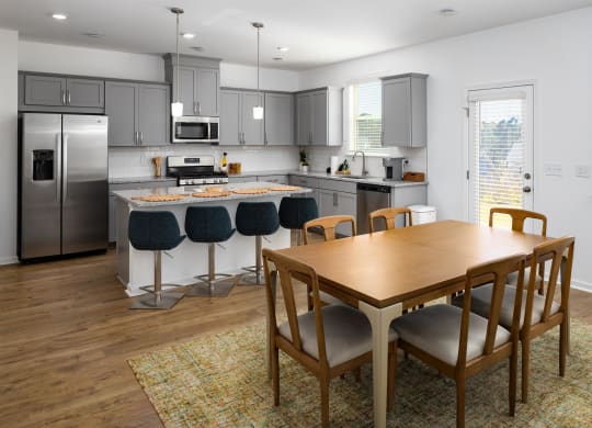 a kitchen and dining room with a table and chairs
