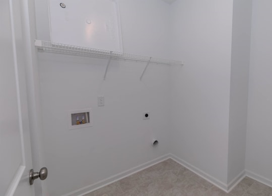 a bedroom with a closet and a wall with a shelf and a door