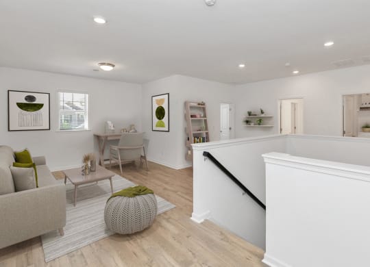a renovated living room with a staircase and a living room and a dining room