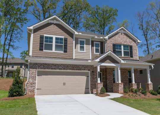 a house with a garage door in front of it