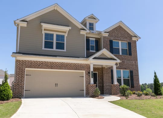 a house with a garage door in front of it