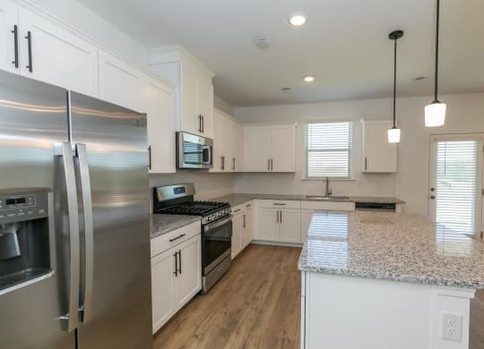 a kitchen with stainless steel appliances and a granite counter top