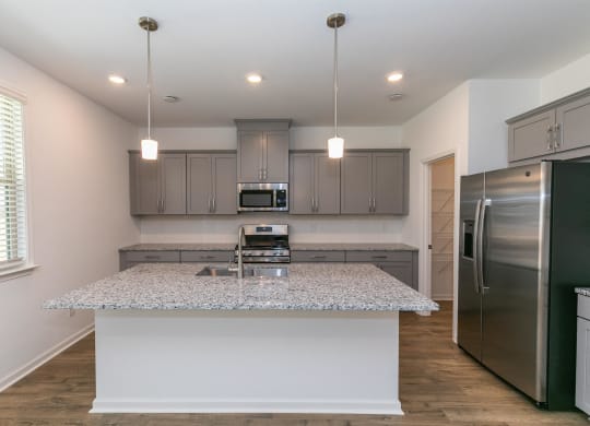 a kitchen with stainless steel appliances and granite counter tops
