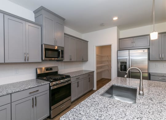 a kitchen with granite counter tops and stainless steel appliances