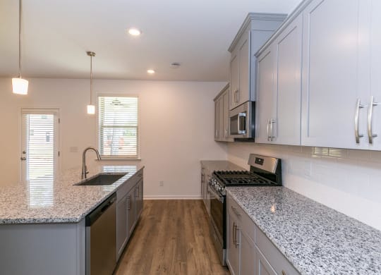 a kitchen with granite counter tops and stainless steel appliances