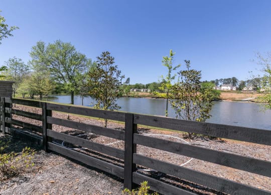 the view of a lake from a wooden fence