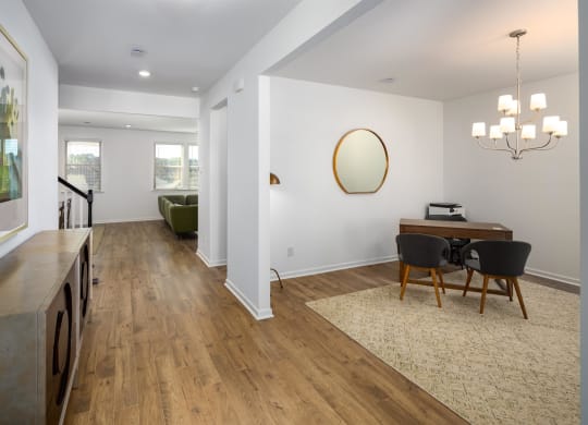 a dining room and living room with a table and chairs