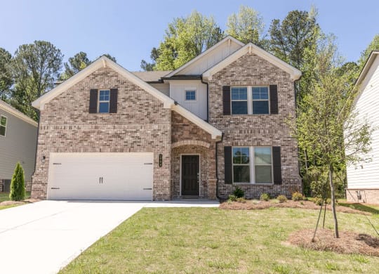 a large brick house with a white garage door