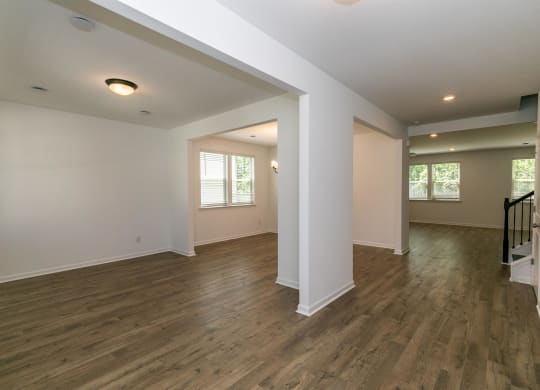 an empty room with a wooden floor and rainbow colored lights