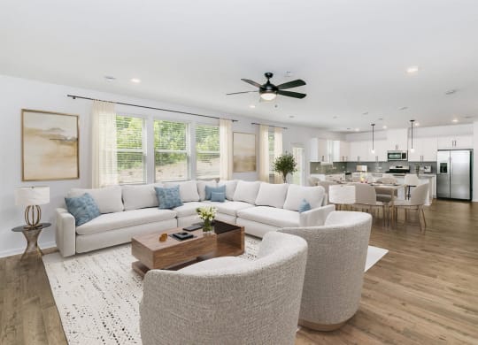 a living room with couches and chairs and a table