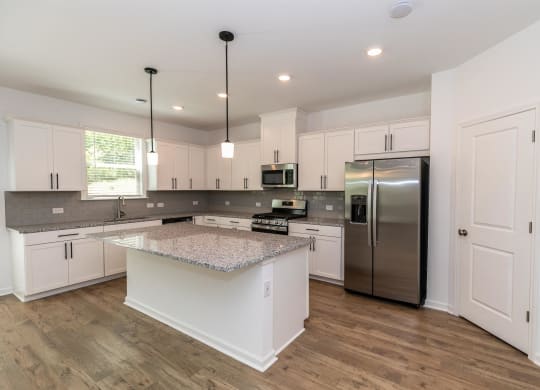 a large kitchen with white cabinets and a counter top