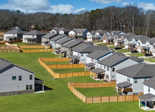 an aerial view of a row of houses in a field