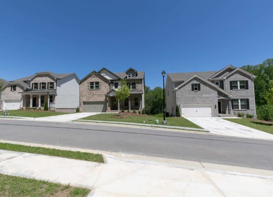 a group of houses on the side of a street