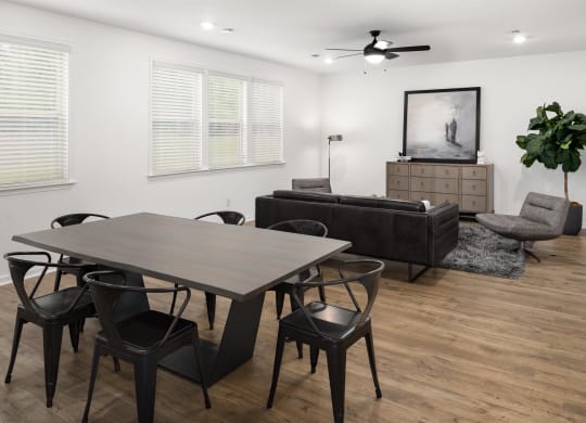 a dining room and living room with a table and chairs