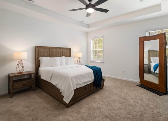 a bedroom with a large bed and a mirror