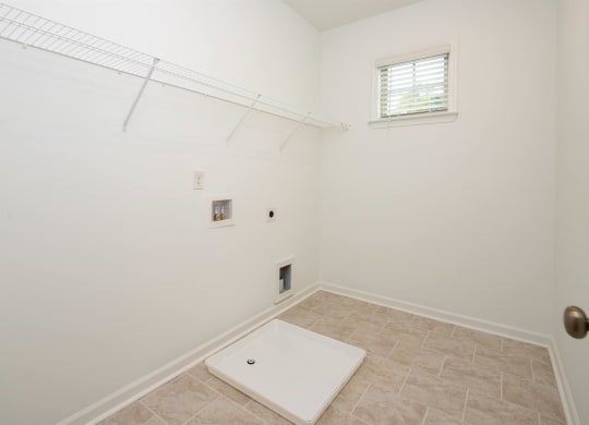 a room with a white wall and a window and a white rug