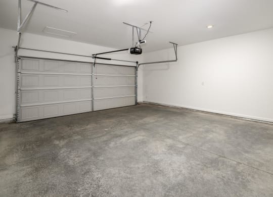 the interior of a garage with a white wall and a garage door