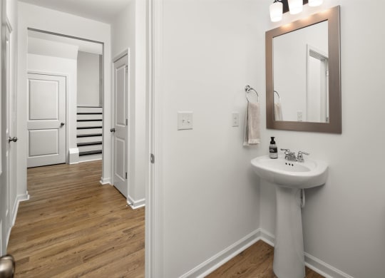 a white bathroom with a sink and a mirror