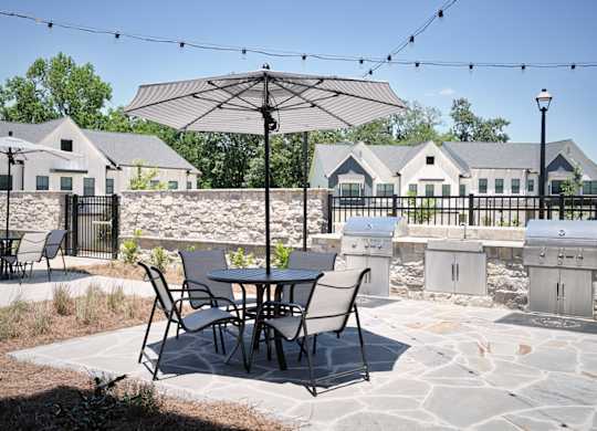 Inviting patio setup with umbrella-covered seating ideal for gatherings or quiet moments.