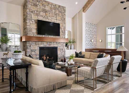 Clubhouse living room with ample seating, fireplace and TV.