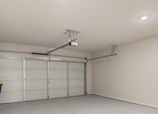 a white garage with white doors and a light on the ceiling