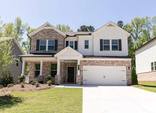 Exterior of the Prescott, two story home with a private driveway and attached garage.