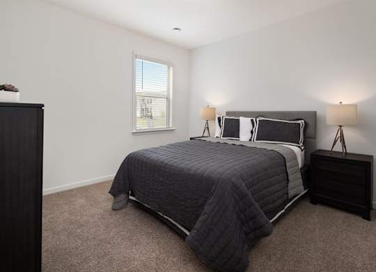 The third bedroom with queen size bed and large window letting in a ton of natural light.