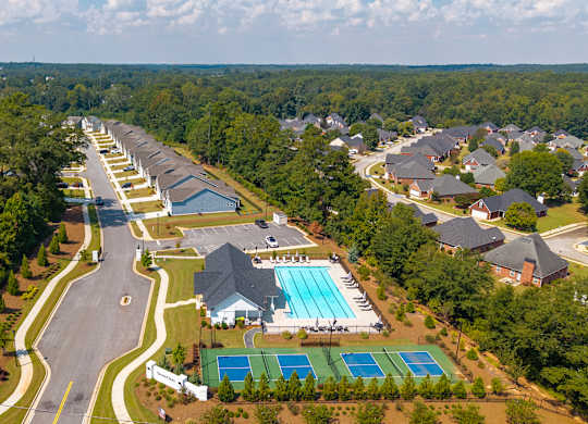 Bird’s-eye view capturing the clubhouse, community amenities, and surrounding homes.