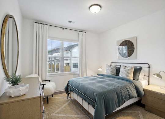 Secondary bedroom with queen size bed and large window letting in a ton of natural light.