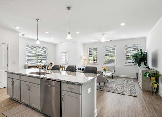 a living room with a kitchen and a dining room