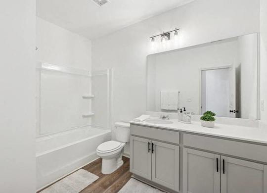 Secondary bathroom with tub shower and single vanity.