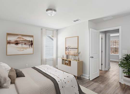 Secondary bedroom with queen bed, large sunlit window.