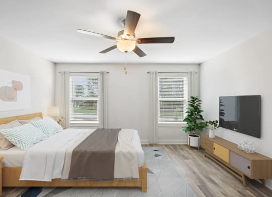 a bedroom with a bed and a ceiling fan