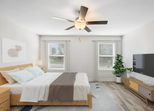 a bedroom with a bed and a ceiling fan