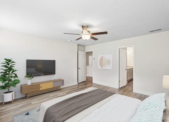 a bedroom with a large bed and a ceiling fan