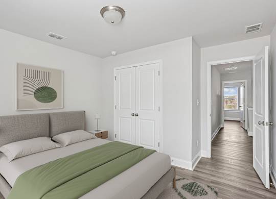 Secondary bedroom with queen size bed and large window letting in a ton of natural light.
