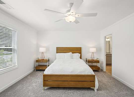a bedroom with a large bed and a ceiling fan
